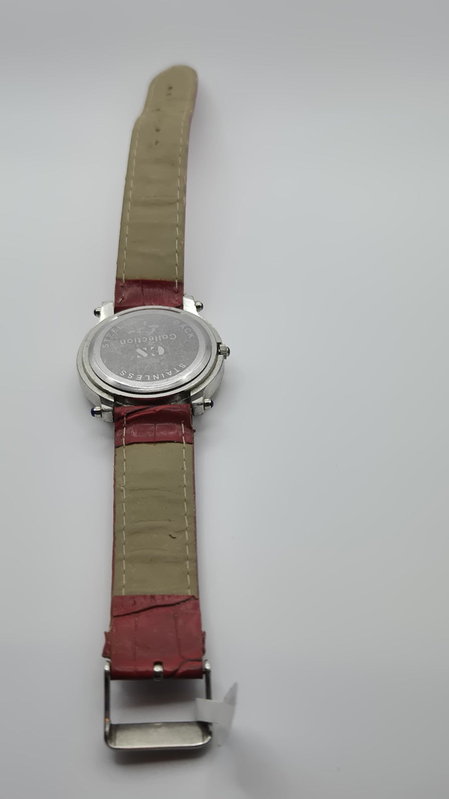 CS Collection Quartz watch with a red band and a crystalstudded bezel.7
