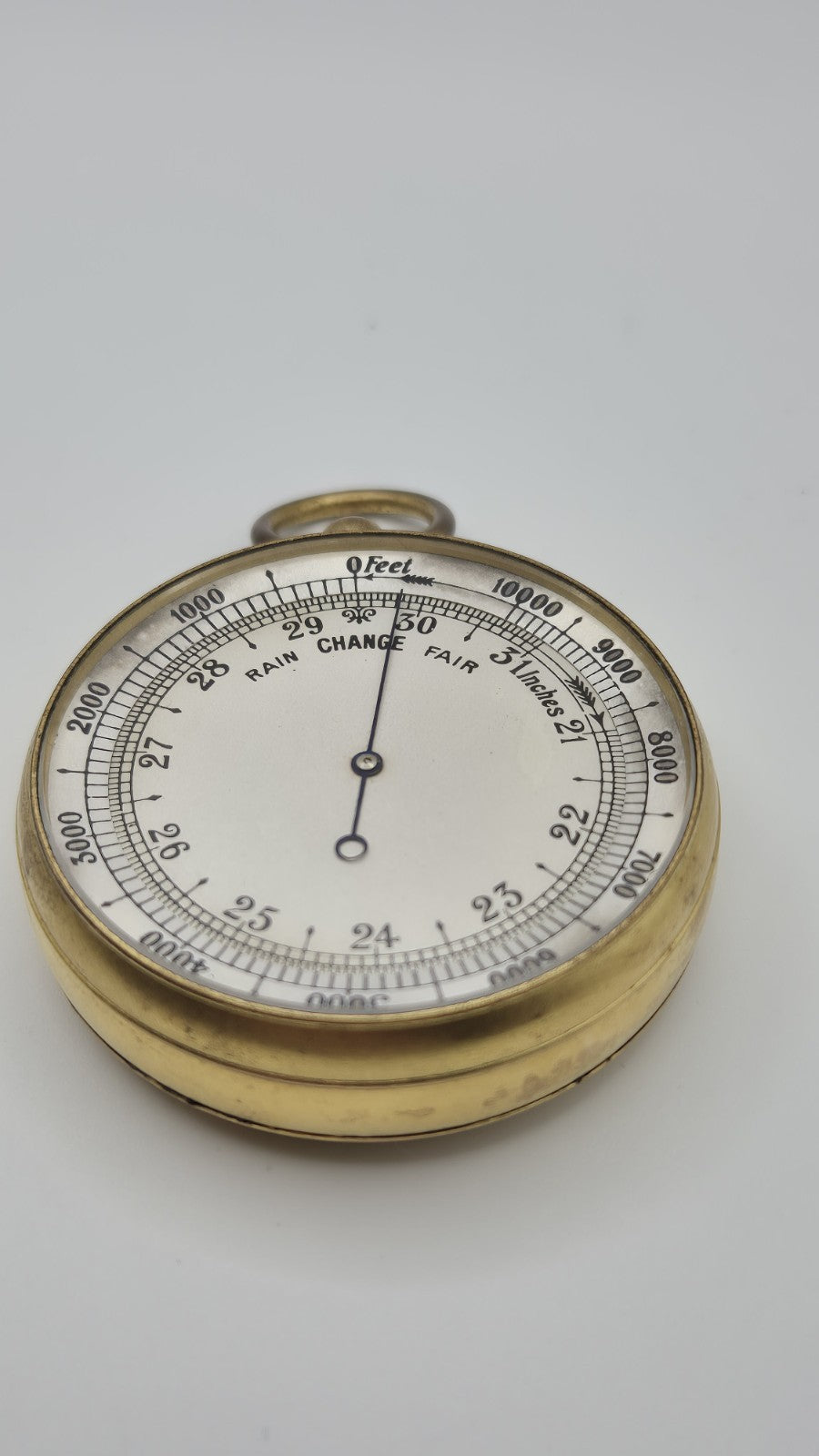 Antique pocket barometer with an altimeter scale in a brass case.5