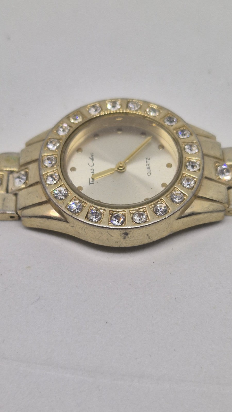 Thomas Calvi analog quartz wristwatch with a goldtoned band and a...6