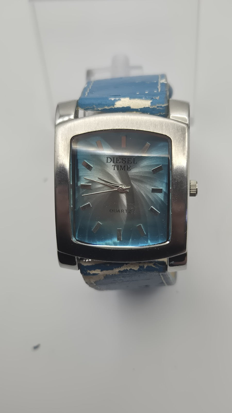 Diesel wristwatch features a rectangular stainless steel case and a blue dial...1