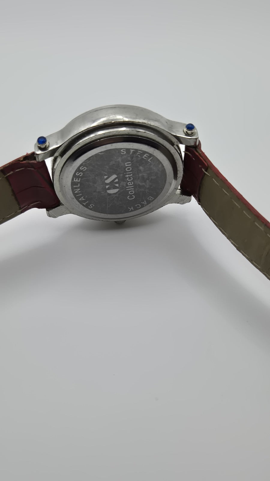 CS Collection Quartz watch with a red band and a crystalstudded bezel.5